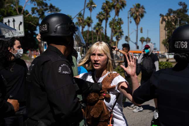 LAPD officers hold back activists as they attempted to walk onto the  110 freeway to protest the overturning of Roe v. Wade on June 25, 2022  in Los Angeles, California