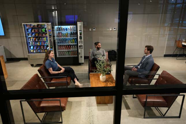 People sit in a waiting lounge at the new Electrify America indoor electric vehicle charging station in San Francisco, Wednesday, Feb. 7, 2024. Electrify America, Tesla, Mercedes and other charging networks are starting to build nicer spots for people to fill up their electric vehicles, knowing they&#39;ll be there for a lot longer than people spend at gas stations. (AP Photo/Eric Risberg)