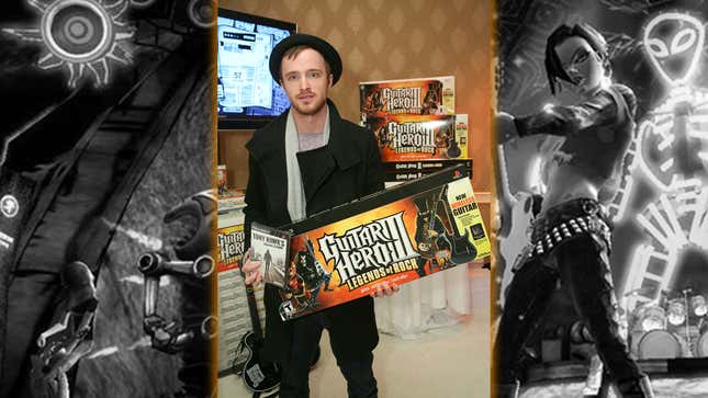 Aaron Paul holds a Guitar Hero III Legends of Rock box. 