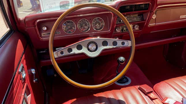 Driver's view of instruments and "rim-blow" steering wheel in a 1971 AMC Hornet SC 360 with a berry interior