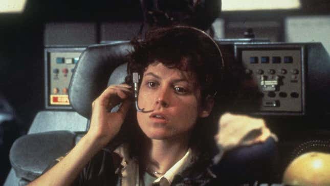 Sigourney Weaver as Ripley in Alien wears a headset while sitting in a cockpit