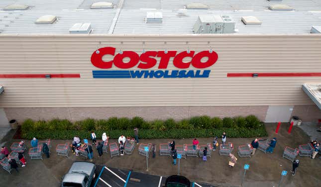 A line of shoppers snakes around a Costco store in Novato, California. 