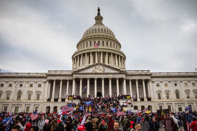 A large group of pro-Trump protesters stands on the East steps of the Capitol Building after storming its grounds on January 6, 2021, in Washington, DC. 