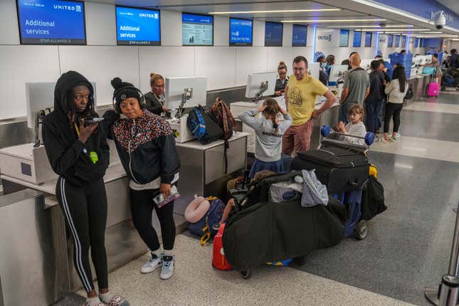 FILE - Travelers await at the departure counter at the United Airlines terminal at Los Angeles International Airport, Wednesday June 28, 2023, in Los Angeles. The U.S. Transportation Department said Wednesday, Nov. 8, 2023, that consumer complaints about airlines nearly doubled in the first three months of this year, compared with the same period last year, and kept soaring in April and May. (AP Photo/Damian Dovarganes, File)