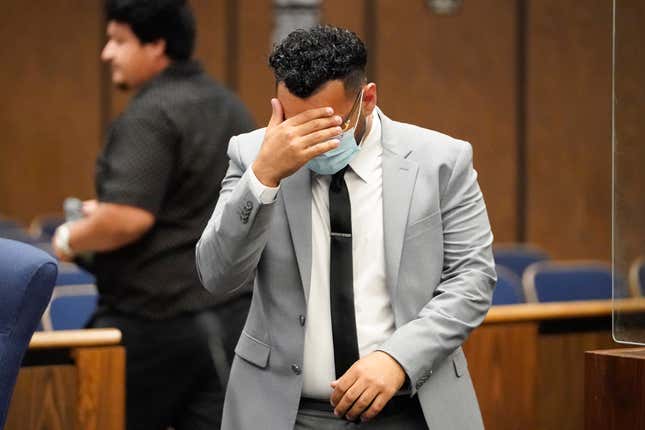 FILE - Kevin Aziz Riad shields his face as he stands in court, Aug. 15, 2023, in Compton, Calif. Aziz Riad, a Tesla driver who pleaded guilty to two counts of vehicular manslaughter with gross negligence for a 2019 car crash in a Los Angeles suburb, will pay more than $23,000 in restitution. The restitution wraps up a case believed to be the first time in the U.S. prosecutors brought felony charges against a motorist who was using a partially automated driving system. (AP Photo/Ryan Sun, File)