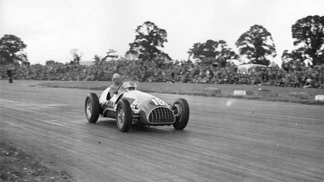 A photo of Alberto Ascari driving his Ferrari at Silverstone. 