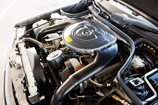 Engine bay of a grey Mercedes-Benz AMG 300CE 6.0 Hammer