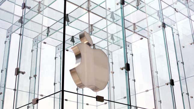 A photo of the Apple logo suspended in glass on a building in New York. 