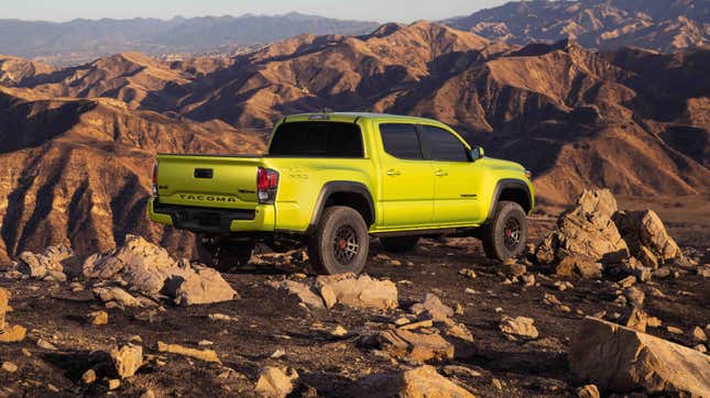 A lime green Toyota Tacoma in a mountainous desert landscape