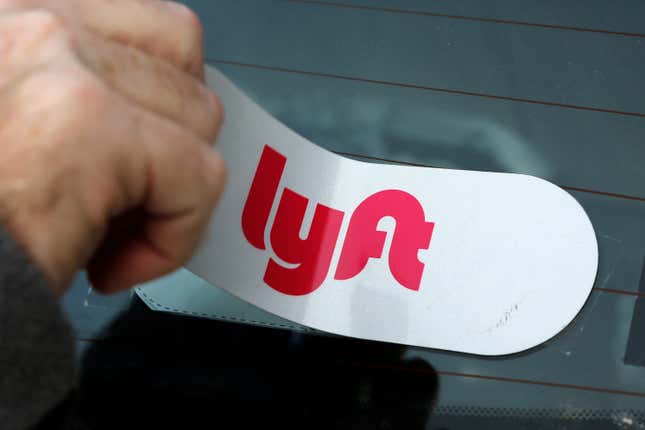 FILE - In this Jan. 31, 2018, file photo, a Lyft logo is installed on a Lyft driver&#39;s car in Pittsburgh. Lyft shares jumped 62% after the bell Tuesday, Feb. 13, 2024 thanks in part to a typo in the the ride-hailing company’s earnings release that sent investors’ auto-trading algorithms — also known as “bots” — into a buying frenzy. (AP Photo/Gene J. Puskar, File)