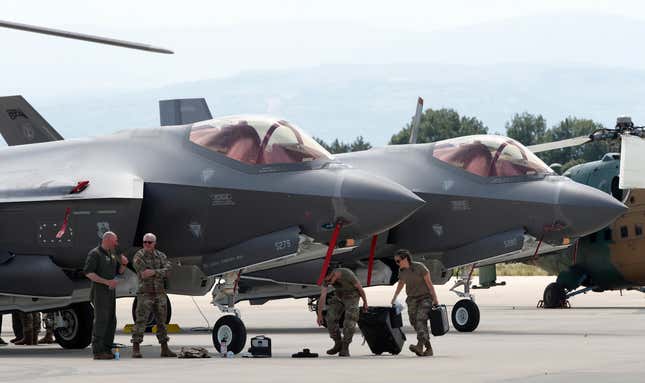 FILE - U.S. military personnel work near F-35 fighter jets of the Vermont Air National Guard, parked in the military base at Skopje Airport, North Macedonia, on Friday, June 17, 2022. The Czech government on Wednesday, Sept. 27, 2023 approved a Defense Ministry plan to acquire 24 U.S. F-35 fighter jets in a deal worth some 150 billion Czech crowns ($6.5 billion). (AP Photo/Boris Grdanoski, file)