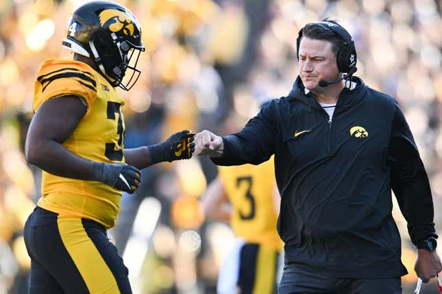 Iowa Hawkeyes assistant coach Brian Ferentz greets Big Ten leading tackler Jay Higgins (34) as he returns to the sideline during the second quarter against the Minnesota Golden Gophers at Kinnick Stadium.