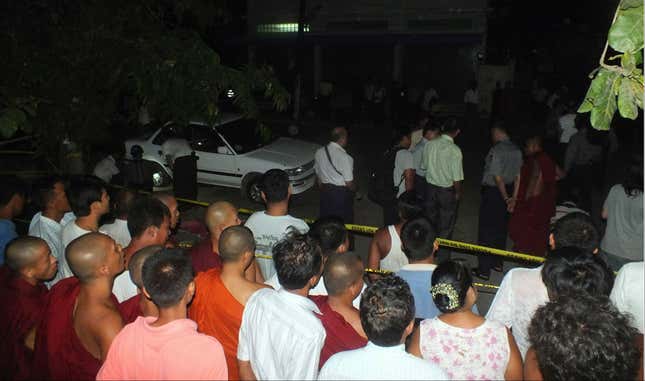 Police and residents examine a car after an explosion went off late on July 21.