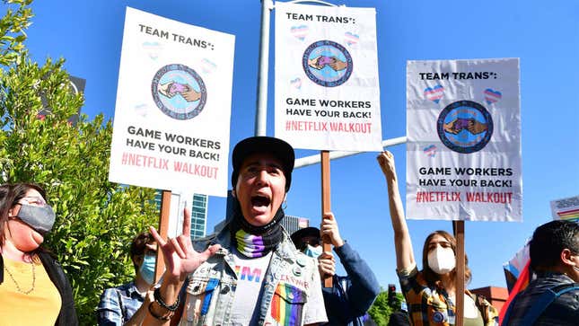 A photo from the Netflix walkout. Employees and supporters hold picket signs with the words "TEAM TRANS."