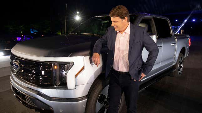 Jim Farley, CEO of Ford Motor Company, poses with the new all-electric F-150 Lightning performance truck at its reveal at Ford World Headquarters on May 19, 2021 in Dearborn, Michigan.