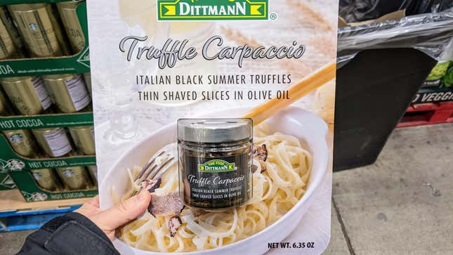 hand holding jar of truffles