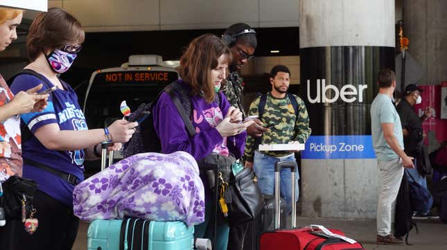 Travelers wait for an Uber ride at Midway International Airport on May 09, 2022 in Chicago, Illinois.