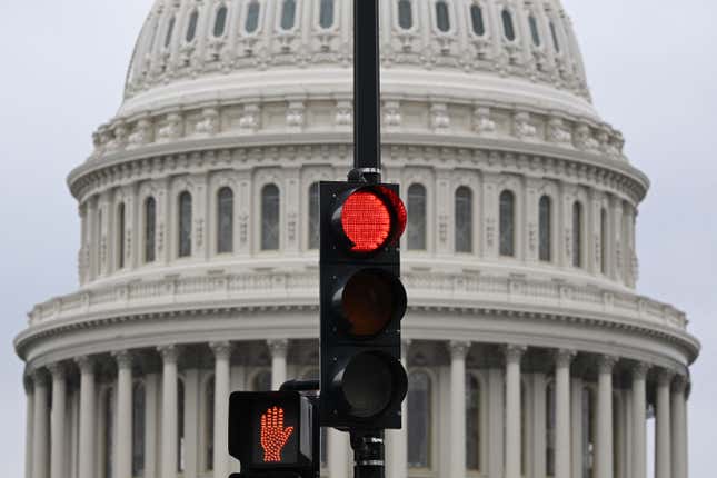 A stoplight is seen in front of the dome of the US Capitol as a government shut down looms in Washington, DC, on September 28, 2023.