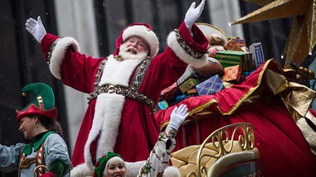Santa Claus waves on a parade float