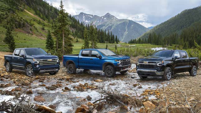 A photo of three Chevrolet Silverado trucks in nature. 