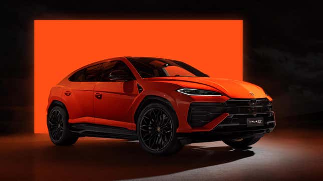 a bright orange Lamborghini urus parked in front of an orange square