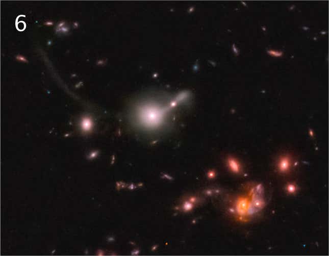 A pinkish galaxy with a tail at center, and a grouping of reddish galaxies at bottom-right.