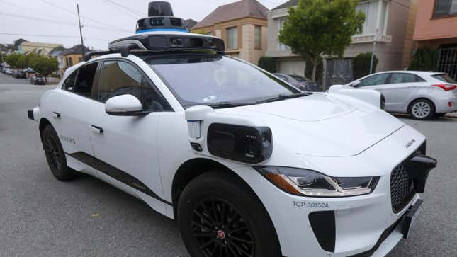 A Waymo Jaguar I-Pace SUV is seen driving on a road in San Francisco, California