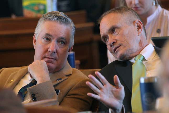 Kansas state Reps. Gary White, left, R-Ashland, confers with Rep. Shannon Francis, R-Liberal, confer as the House votes on legislation, Wednesday, March 27, 2024, at the Statehouse in Topeka, Kan. The two lawmakers support a measure approved by the House to limit ownership of land by people and companies from China and other U.S. adversaries. (AP Photo/John Hanna)