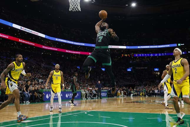 Nov 1, 2023; Boston, Massachusetts, USA; Boston Celtics guard Jaylen Brown (7) goes through the Indiana Pacers defense to dunk during the first quarter at TD Garden.