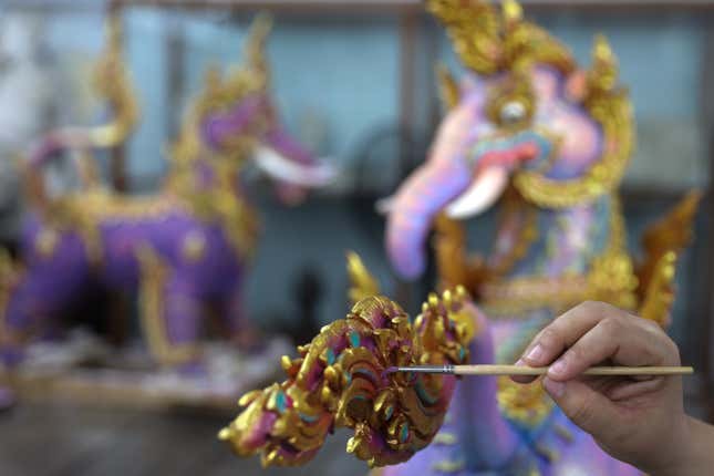 An artist worked in September on a detail of a deity sculpture that will decorate the funeral pyre.