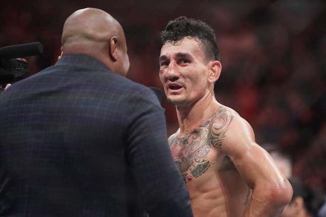 Apr 15, 2023; Kansas City, Missouri, USA; Max Holloway (red gloves) reacts after the fight against Arnold Allen (blue gloves) during UFC Fight Night at T-Mobile Center.