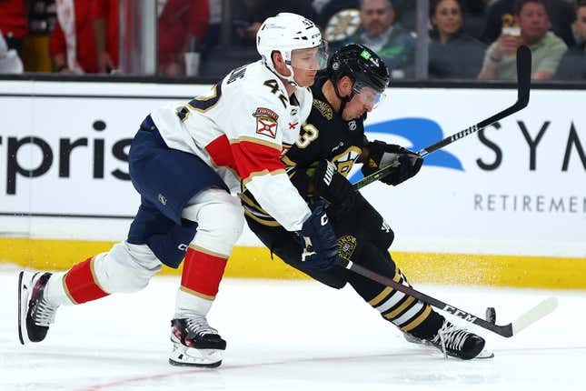 BOSTON, MASSACHUSETTS - OCTOBER 30: Brad Marchand #63 of the Boston Bruins and Gustav Forsling #42 of the Florida Panthers battle for control of the puck during the first period at TD Garden on October 30, 2023 in Boston, Massachusetts. (Photo by Maddie Meyer/Getty Images)