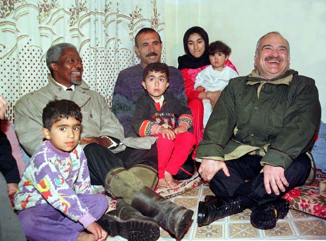 United Nations Secretary General Kofi Annan (L) and Jordan's Crown Prince Hassan (R ) meet with a Palestinian family during their tour at Hitteen Palestinian refugee camp near Amman March 18. Annan on the first leg of a nine-day tour of the Middle East is expected to discuss latest regional developments with its leaders.