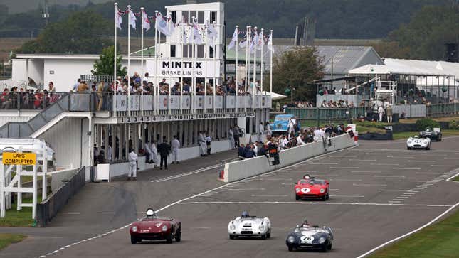 A photo of vintage cars racing at a track day in the UK. 