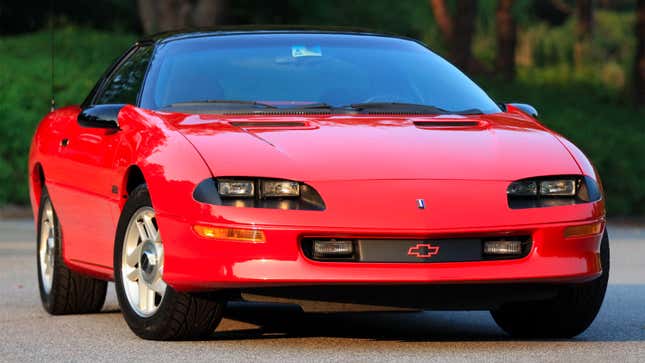 A photo of a red Chevrolet from the 1990s. 