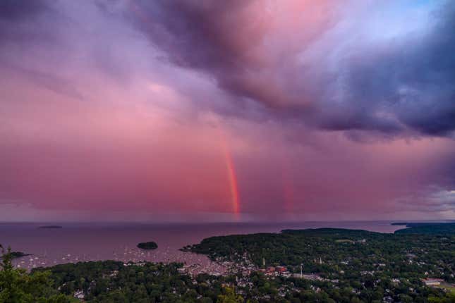 FILE - A rainstorm moves over the Atlantic Ocean after passing through Camden, Maine, at sunset Aug. 1, 2023. Environmental groups on Wednesday Oct. 25, 2025 urged a moratorium on deep sea mining ahead of an international meeting in Jamaica where a U.N. body will debate the issue. (AP Photo/Robert F. Bukaty, File)