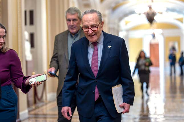 Senate Majority Leader Chuck Schumer, D-N.Y., walks outside the chamber as he tries to assemble enough lawmakers to begin the final steps of completing a partial government funding bill, at the Capitol in Washington, Friday, March 8, 2024. (AP Photo/J. Scott Applewhite)