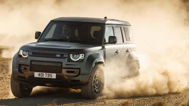 A land rover defender octa driving in dirt