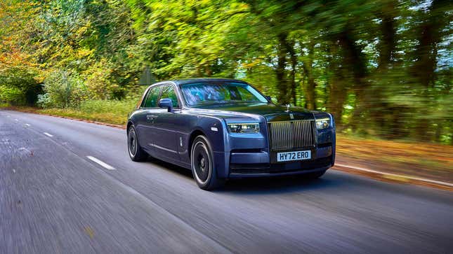 A Rolls-Royce Phantom driving down a two-lane country road