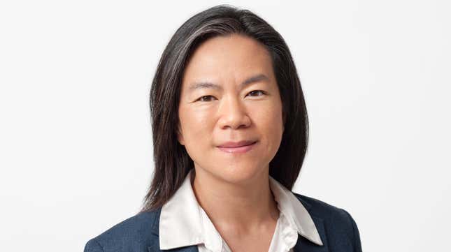 Sissie Hsiao's headshot, a white button up collar can be seen over a dark blue blazer, Sissie is Asian and smiling at the camera