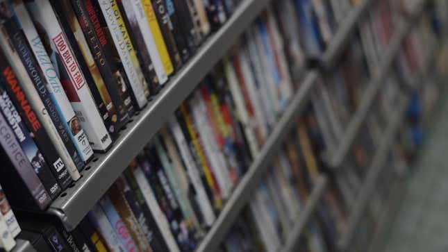 A shelf of DVD cases in a store. 