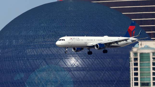 A Delta Air Lines plane in front of the Sphere