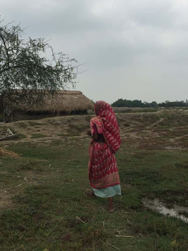 A research participant walking towards her house in West Bengal.