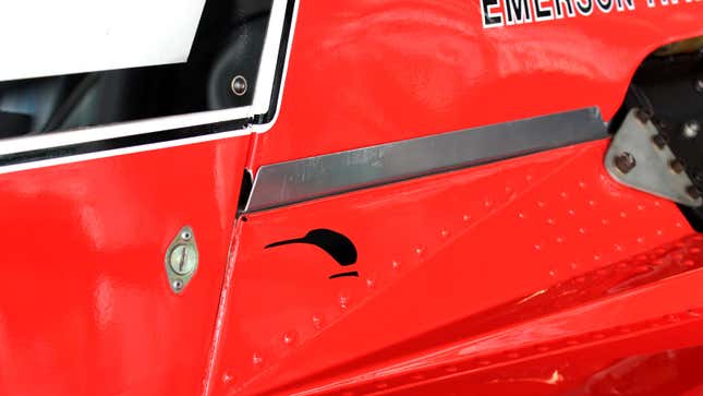 A photo of the McLaren Kiwi logo on a vintage F1 car. 