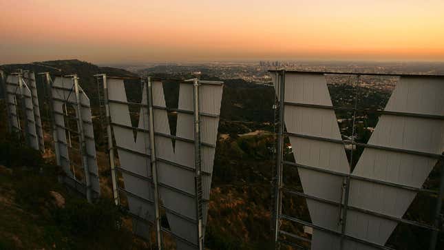 A photo looking at the LA skyline over the Hollywood sign. 