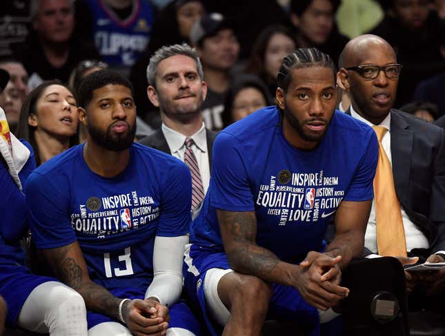 Paul George and Kawhi Leonard #2 of the Los Angeles Clippers follow the game from the bench against Minnesota Timberwolves at Staples Center on February 1, 2020 in Los Angeles, California. 