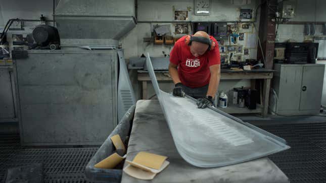 A photo of a person working in the bodyshop at Morgan cars. 