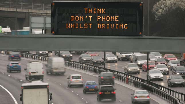 A photo of a sign saying "don't phone whilst driving".