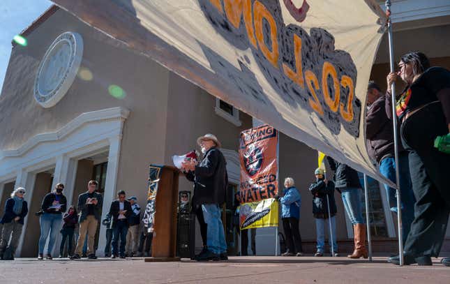 Norm Gaume, a water resources engineer, speaks at a protest against an initiative by Gov. Michelle Lujan Grisham to develop a strategic new source of water, buying treated water that is the byproduct of oil and natural gas drilling, then treating it and selling it back to industry. Around 35 people attended the rally included speakers by Wild Earth Guardians and No False Solutions outside the State Capitol, in Santa Fe, N.M., Monday, Jan. 22, 2024. (Eddie Moore/The Albuquerque Journal via AP)