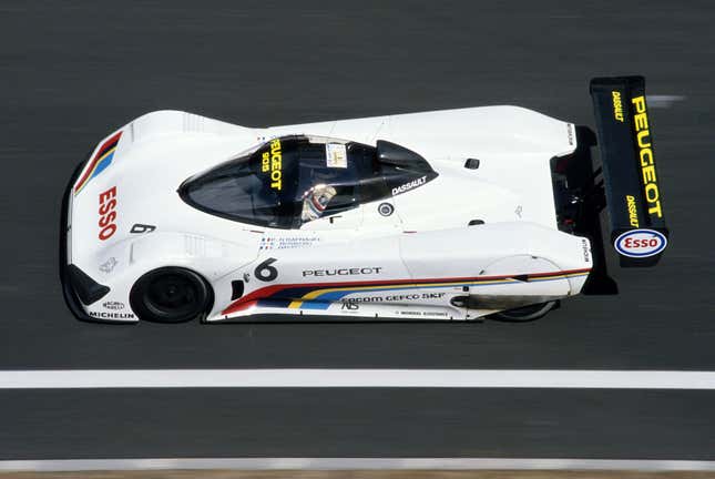 A photo of the original Peugeot 905 chassis, seen at speed in side profile and slightly above.